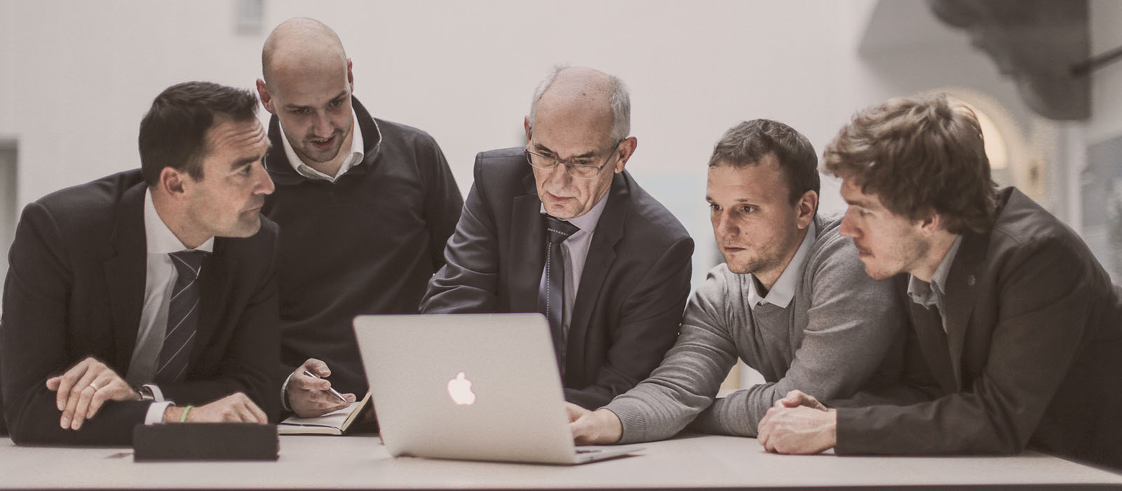 Iuuri attorneys collaborating around a laptop
